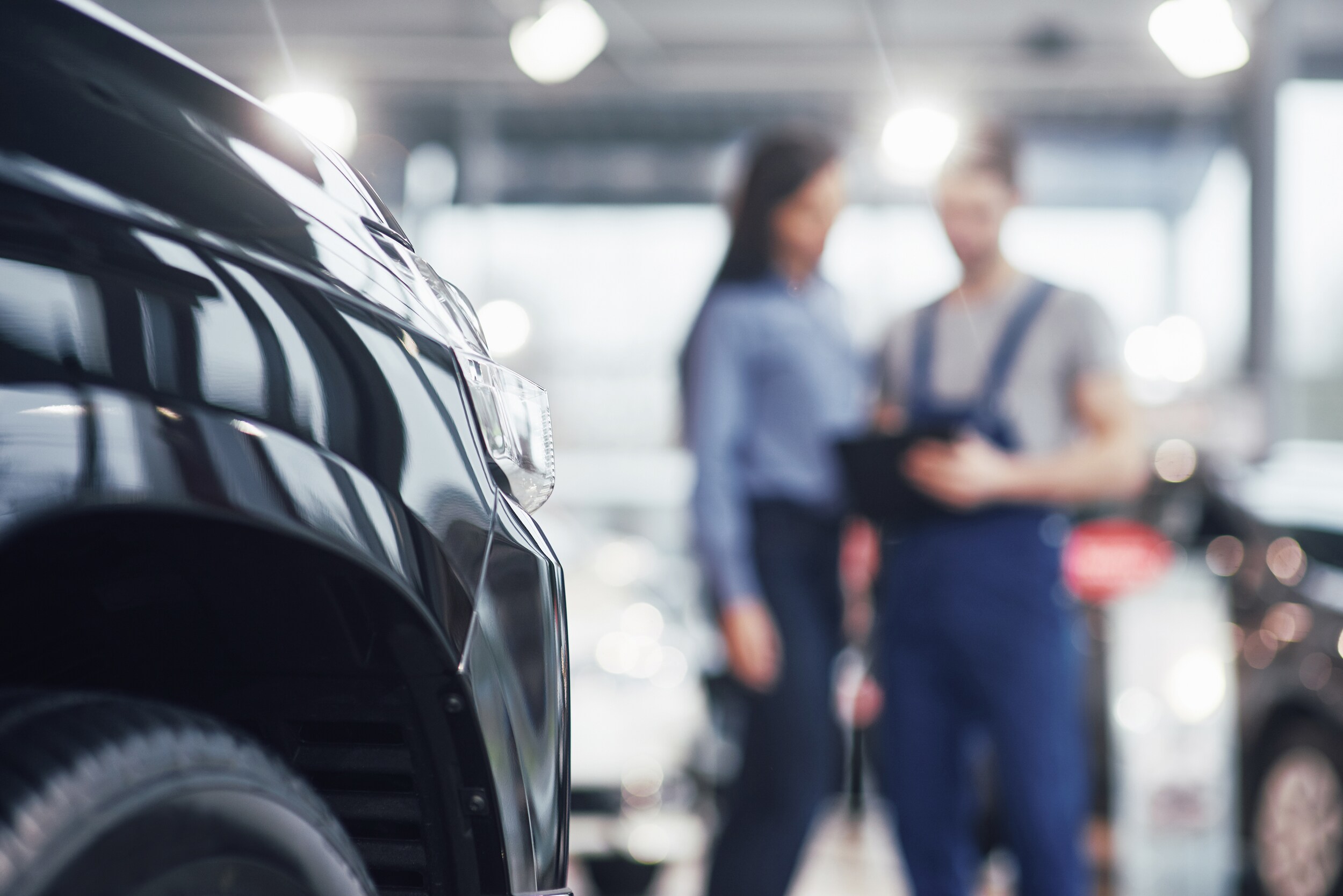 Technician and customer reviewing a Young Auto Care vehicle inspection at a Young Ford service center in Utah