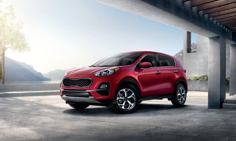 2020 Kia Sportage A red 2020 Kia Sportage parked under a bridge by a lake