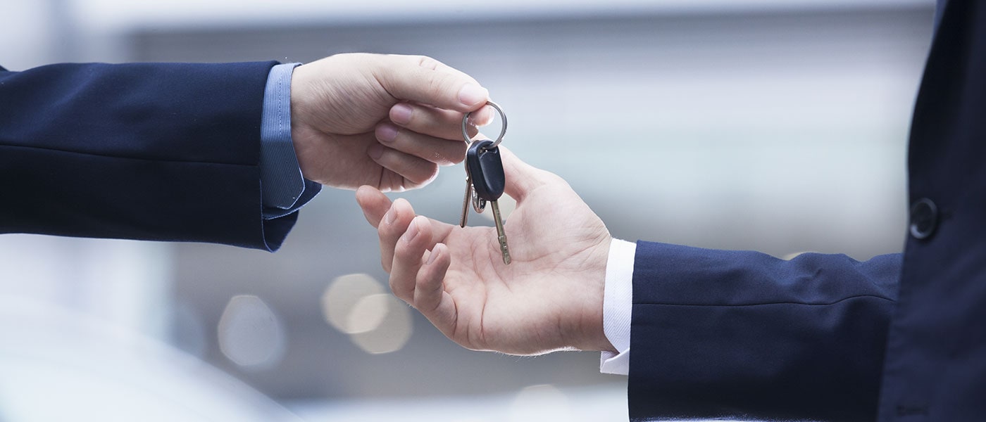 Youngblood Kia Finance A person handing keys to another person