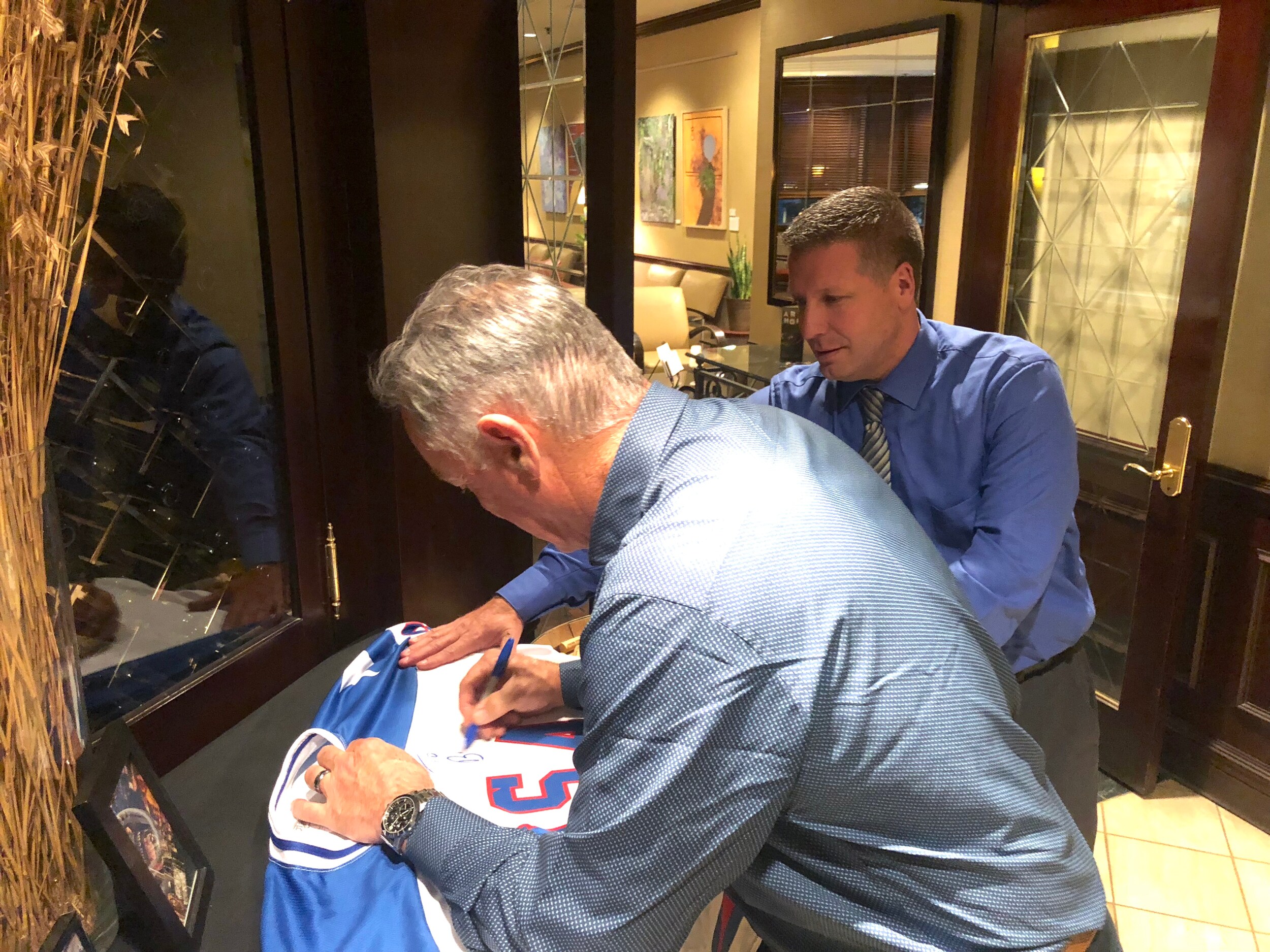 jim craig signing a jersey - legacy award winner - zeigler auto group.jpg