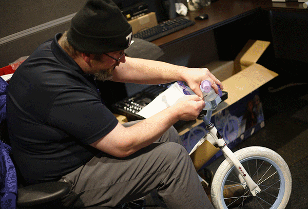 Thompson techs assemble toys for the holidays