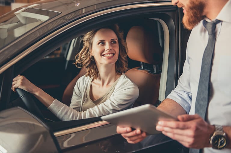 A woman test drives a vehicle