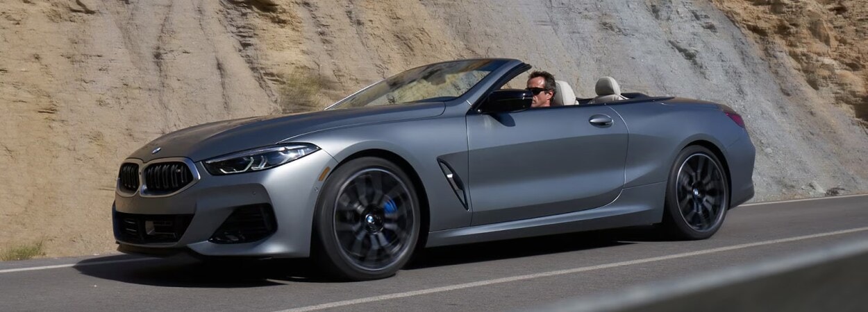 Driving BMW sedan on road