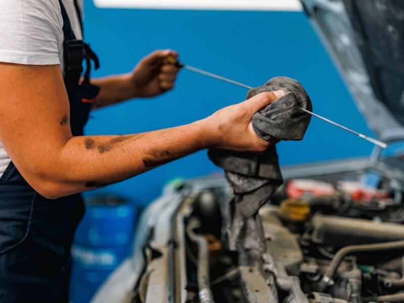 Technician checking oil levels