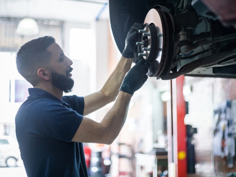 Technician changing brakes