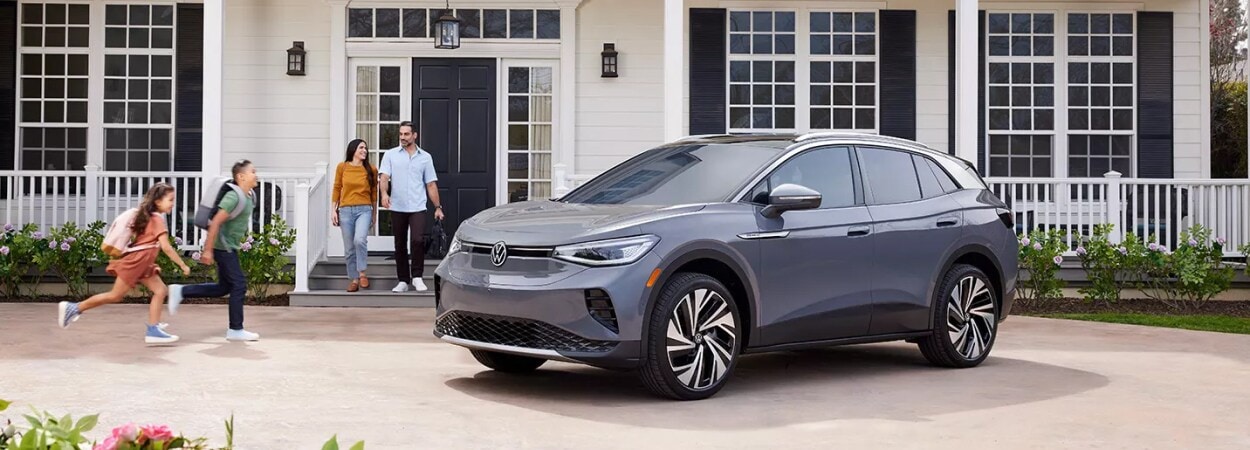 Family walking towards the KIA SUV