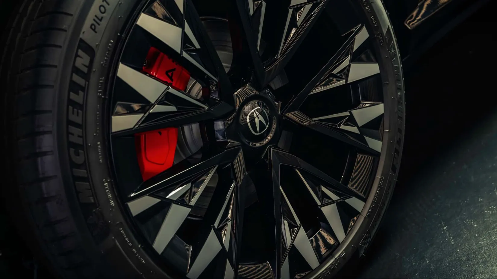 Close-up of Acura RSX EV wheel and red brake caliper