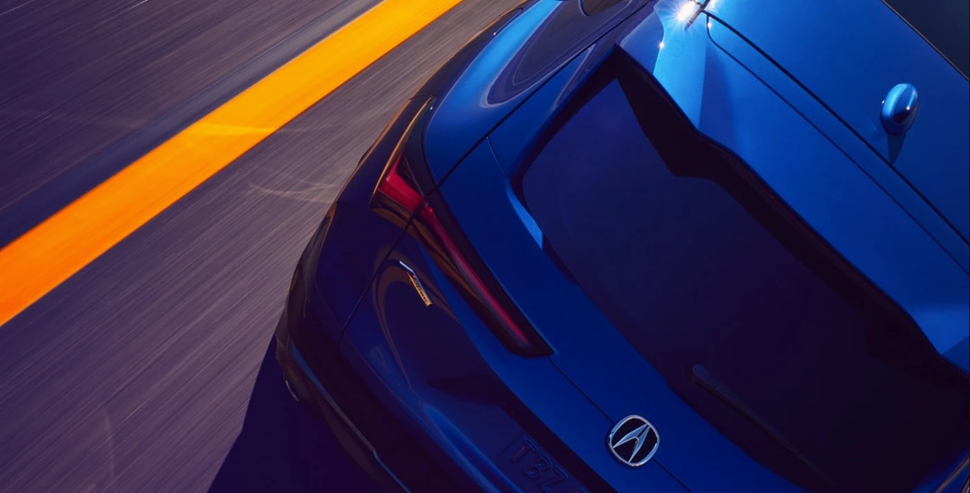 Rear view of a used Acura ADX driving on the road near West Palm Beach, FL