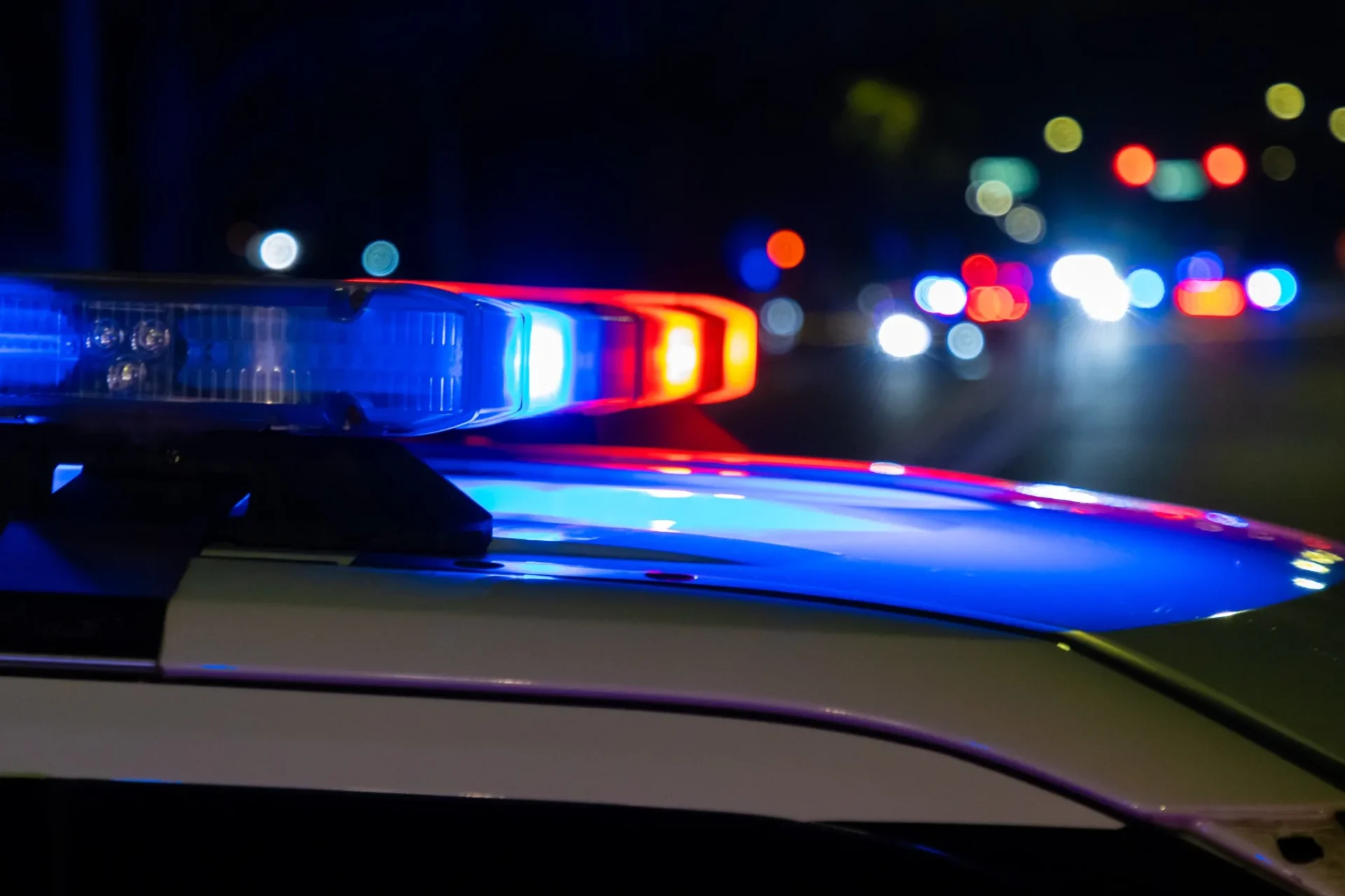 Police cruiser lights at night — LoJack partners with law enforcement to recover stolen vehicles across West Palm Beach and Palm Beach County.