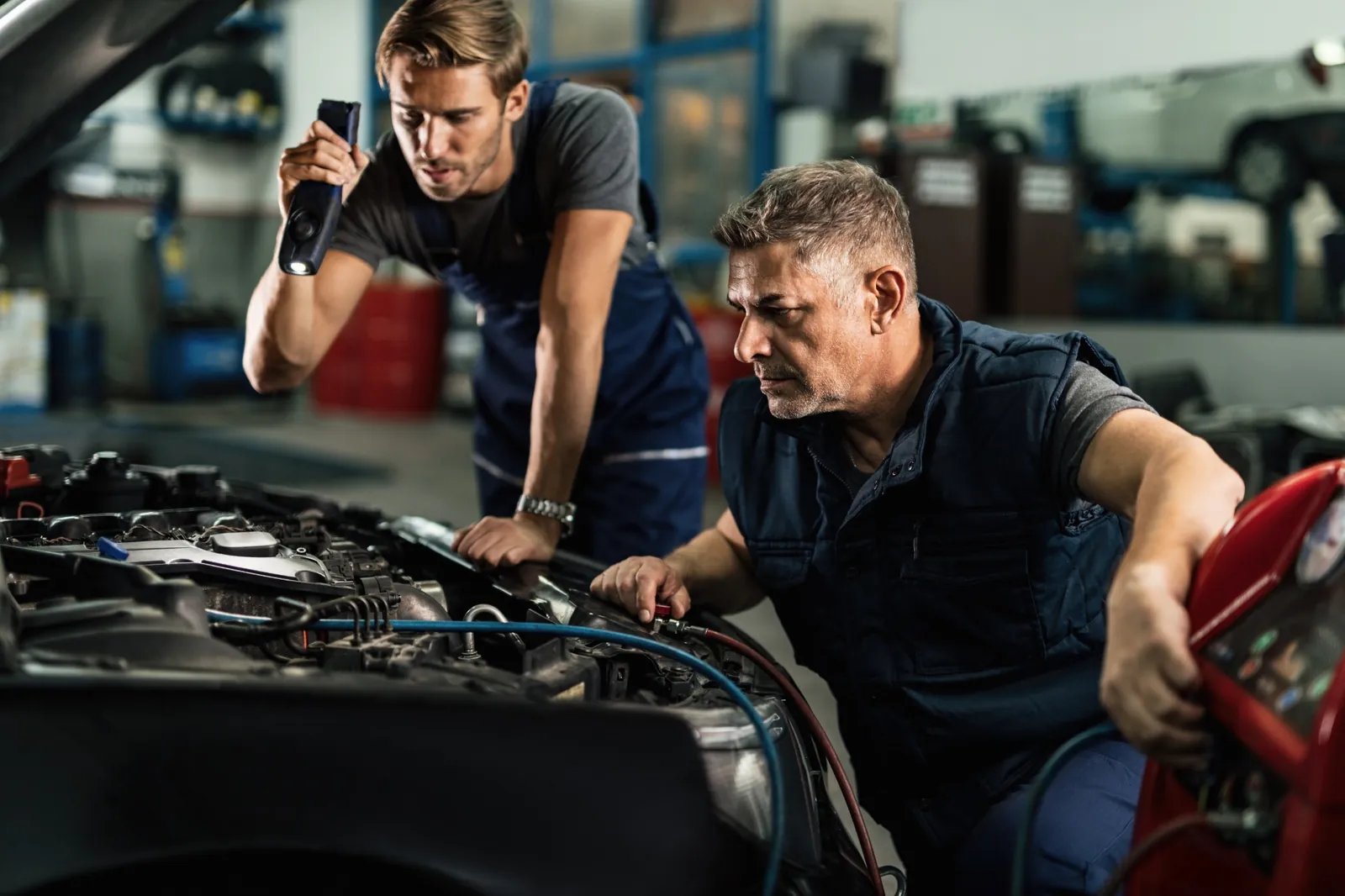 Acura service technicians diagnosing an air conditioning system