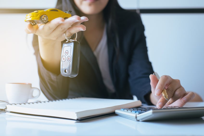 Woman with a yellow toy car and car keys