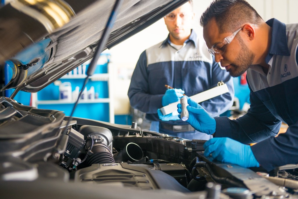 Acura service technicians performing an inspection