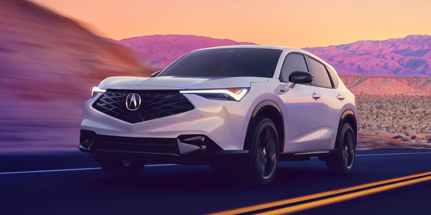 2026 Acura ADX driving past colorful mountains
