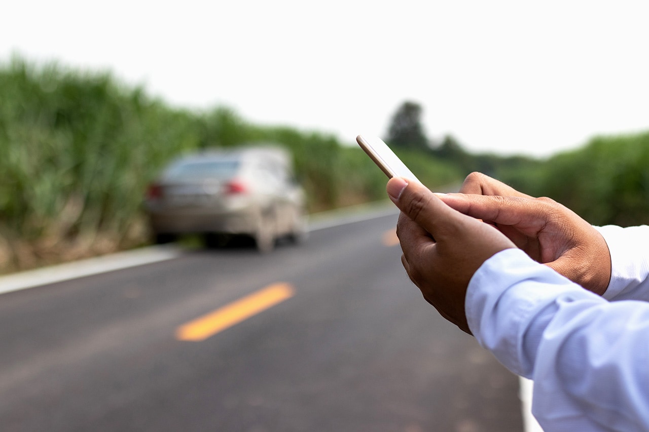Driver standing near broken-down car.jpg