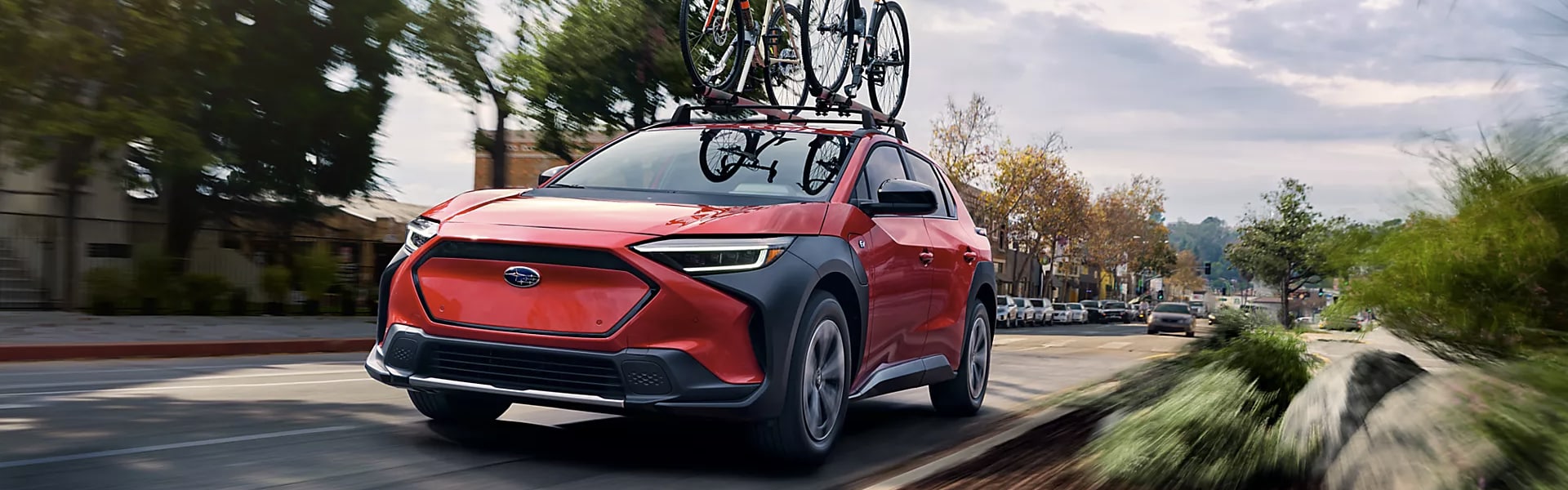 2024 Subaru Solterra running on city street carrying bicycle
