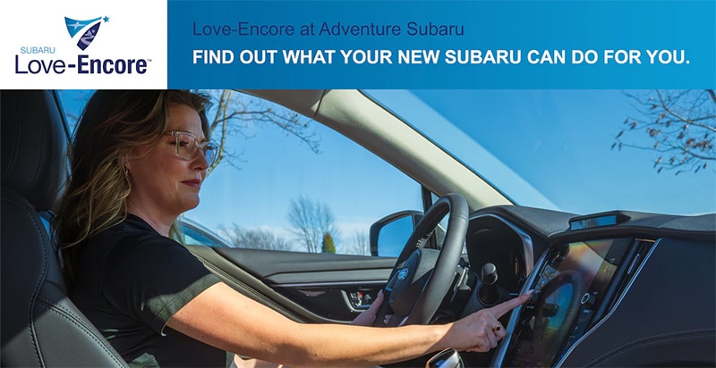 Subaru Encore Delivery Specialist helping a customer learn their new Subaru's technology features at Adventure Subaru