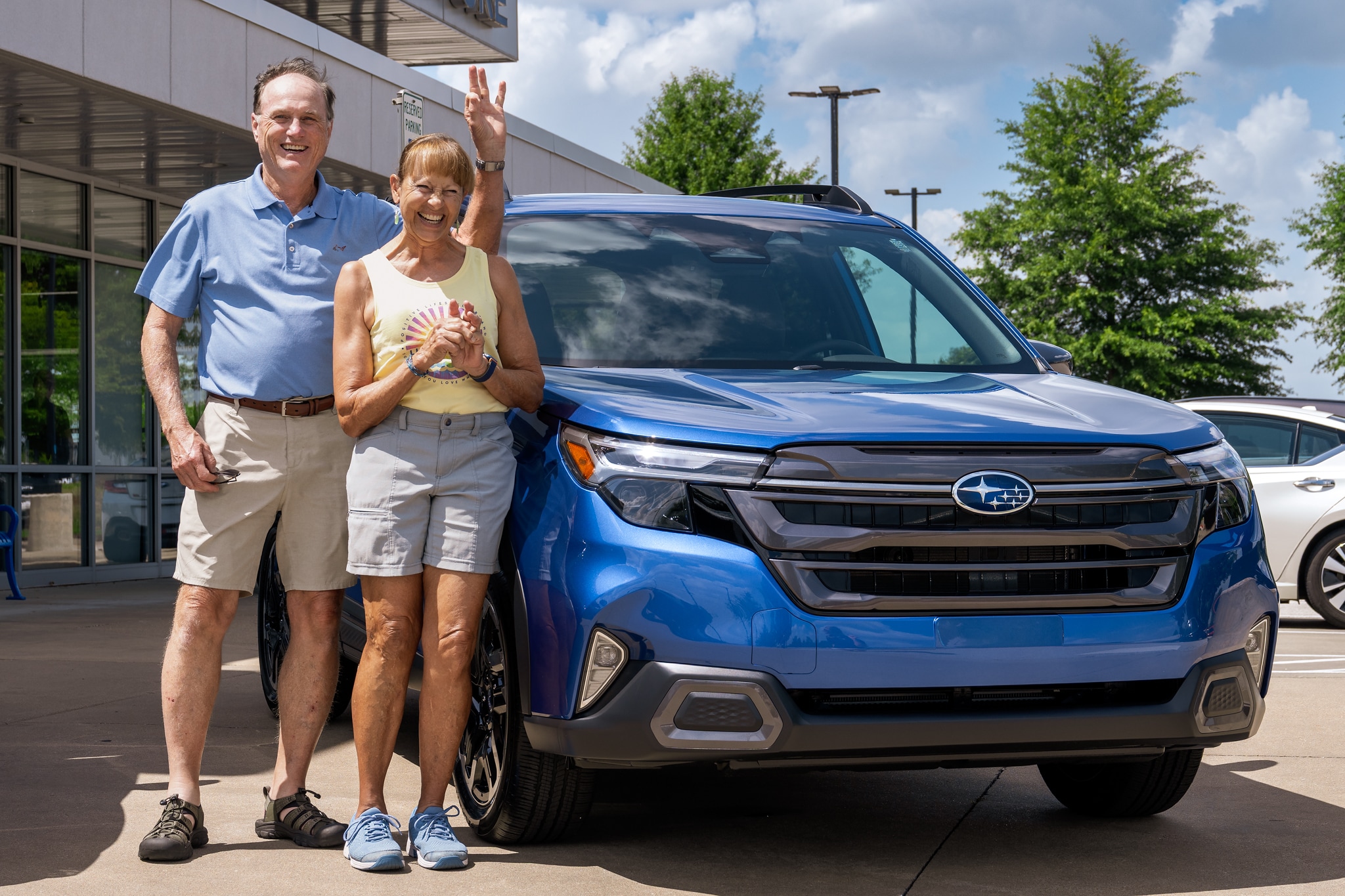 Customers posing with their new Subaru Forester at Adventure Subaru in Fayetteville, AR