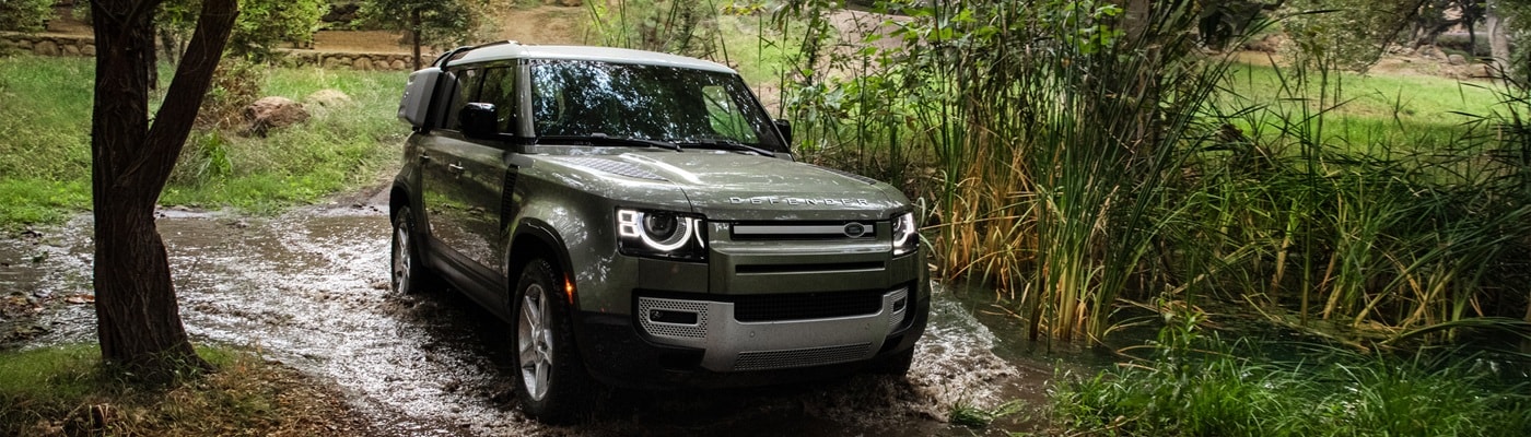 Defender 110 fording a swampy river