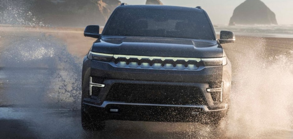 2026 Jeep® Grand Wagoneer REEV driving through the beach.