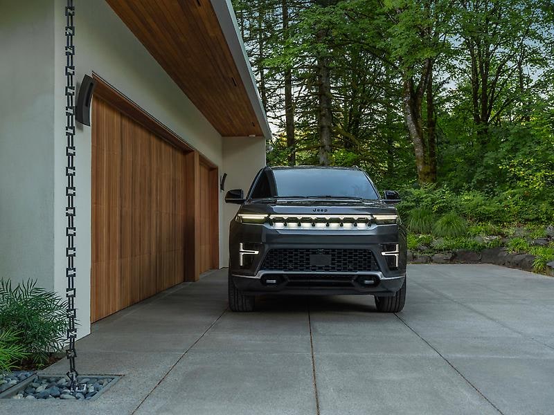 2026 Grand Waggoneer parked in front of modern home.