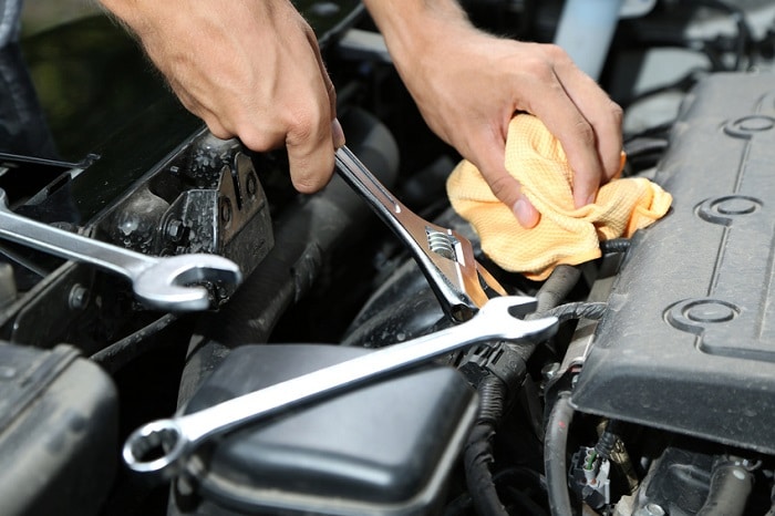 Mechanic_Working_With_Wrench_Inside_Car.jpg