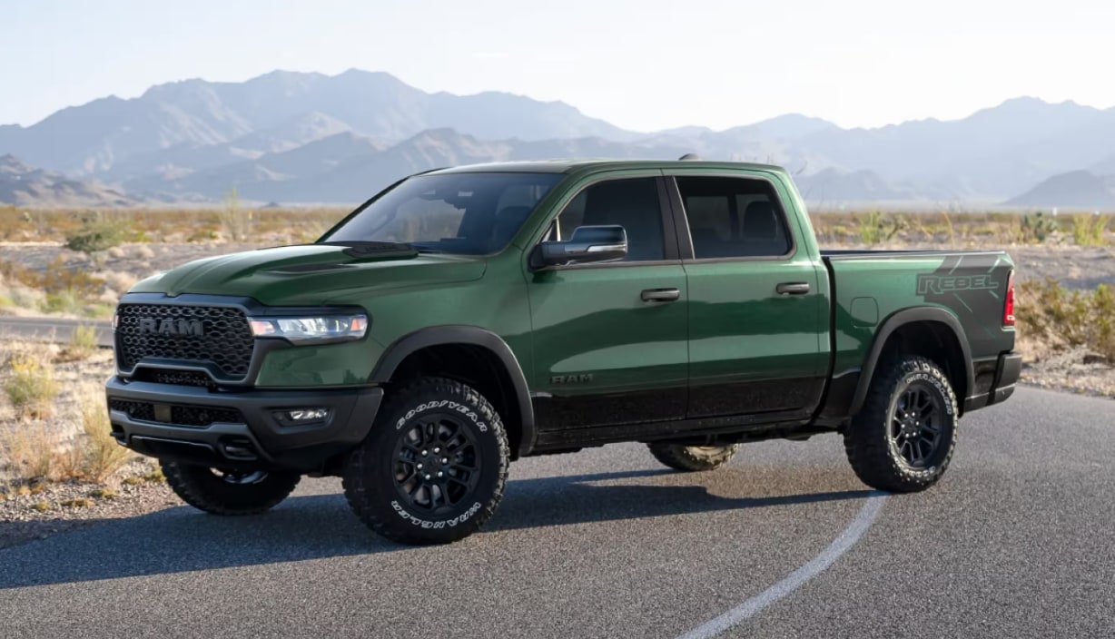 Screenshot%202025-08-14%20161638.png Forrest Green 2026 GMC 1500 parked in the middle of a desert road with mountains in the background.