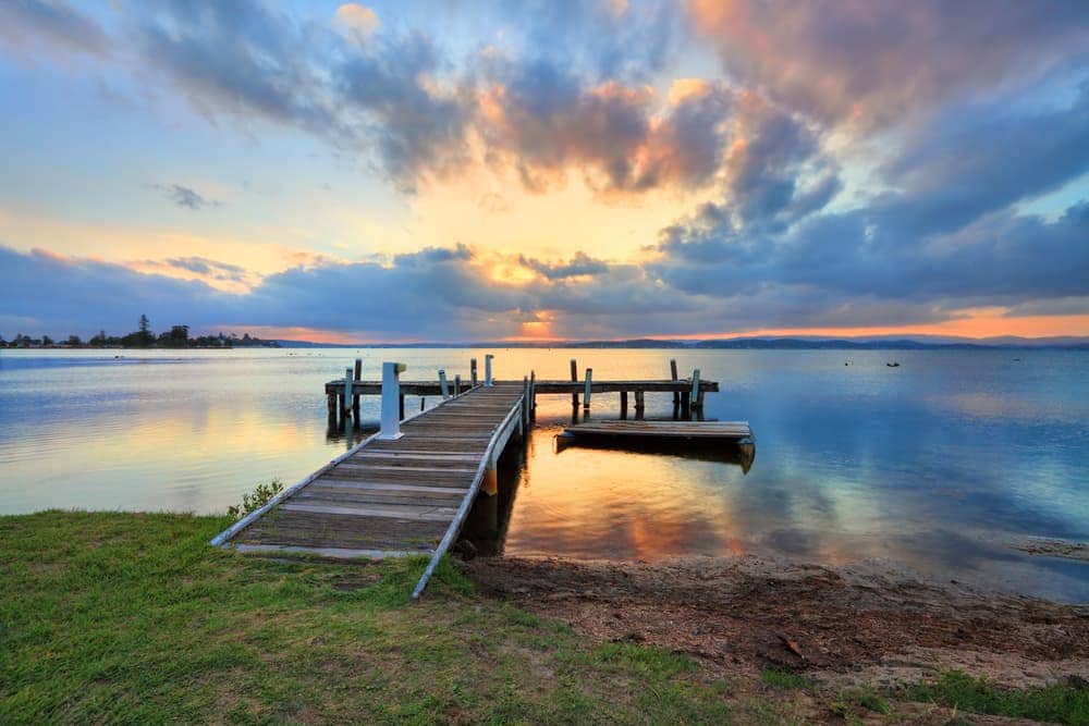 lake and board walk amongst sunset