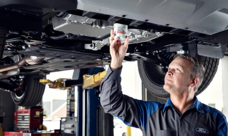 Ford Service Technician replacing oil filter