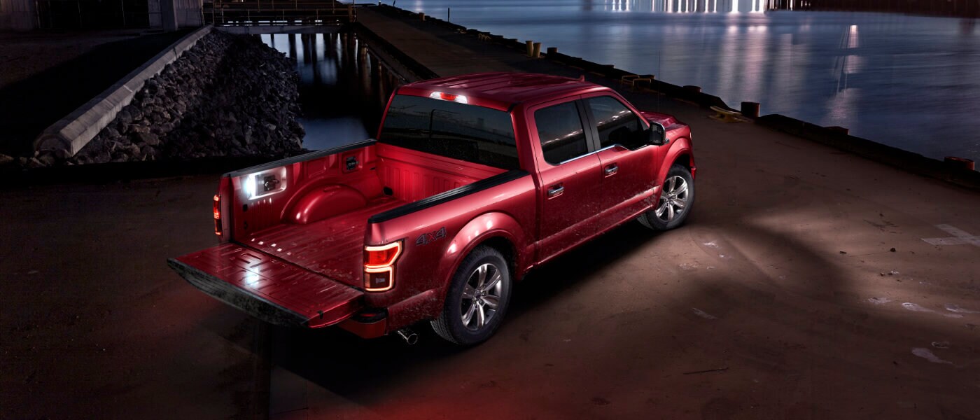 2020 Ford F-150 parked at night by a dock near water