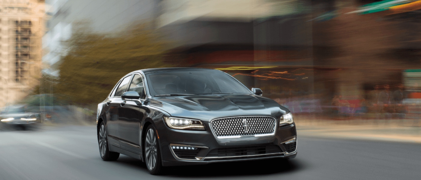 Black 2019 Lincoln MKZ driving front exterior view