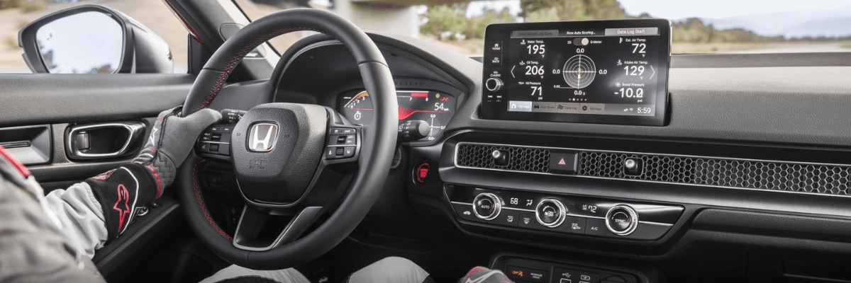Honda Civic interior with sport steering wheel and large touchscreen display