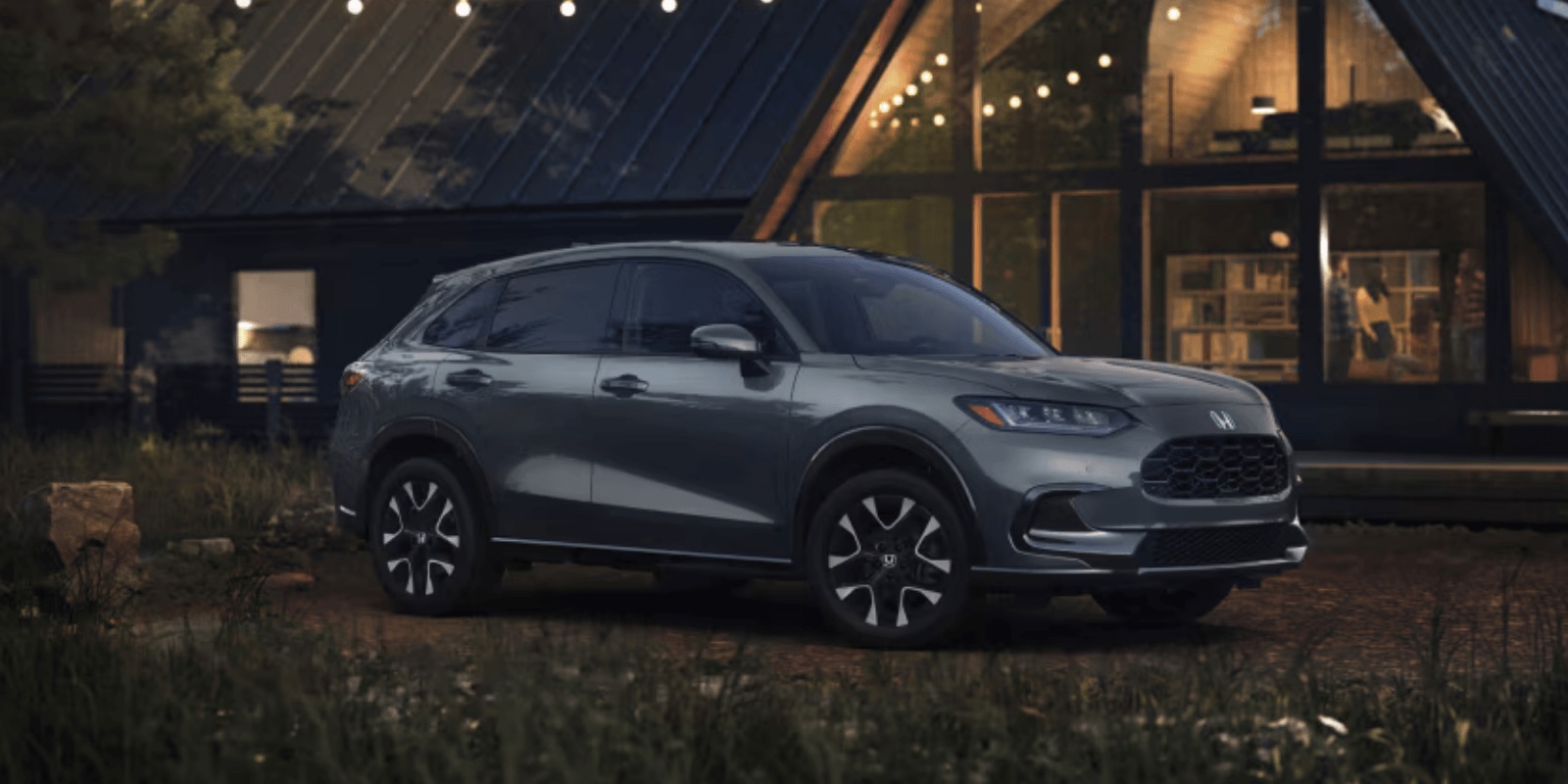 Reliable used Gray Honda CR-V car parked outside a modern cabin at night with string lights