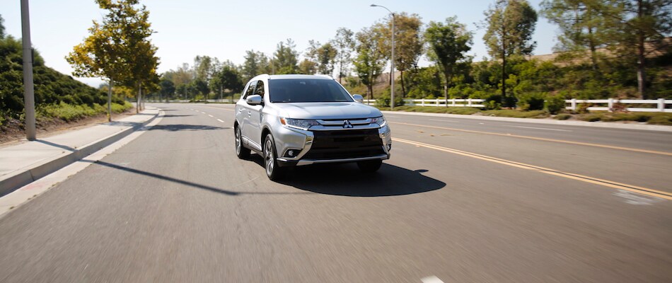 2018 Outlander Trims A silver 2018 Outlander driving through the suburbs