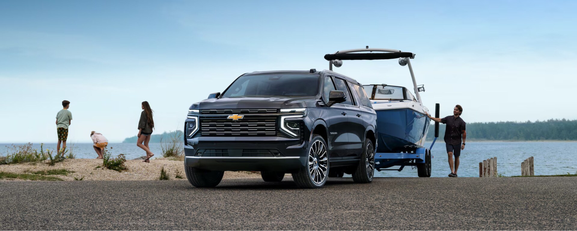 A suburban pulling a boat.