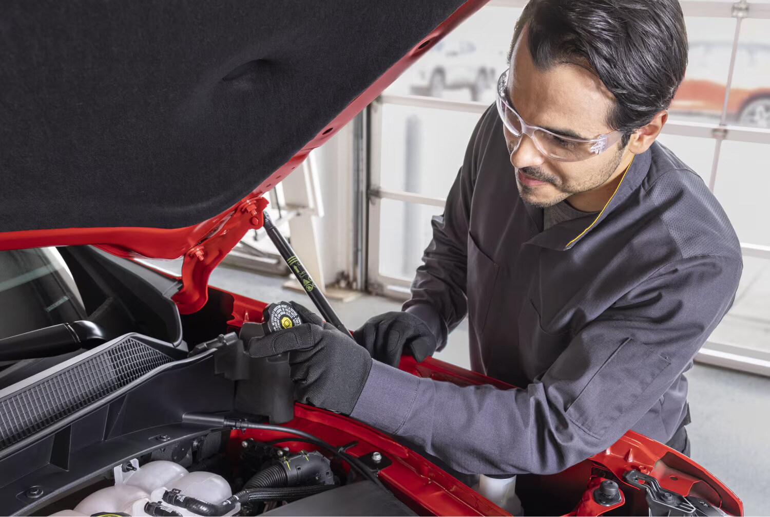  a view of a chevy service member working on a chevy vehicle
