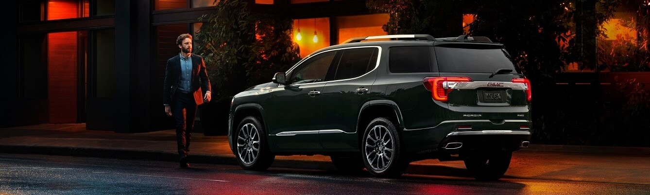 Man Walking to His New GMC Acadia