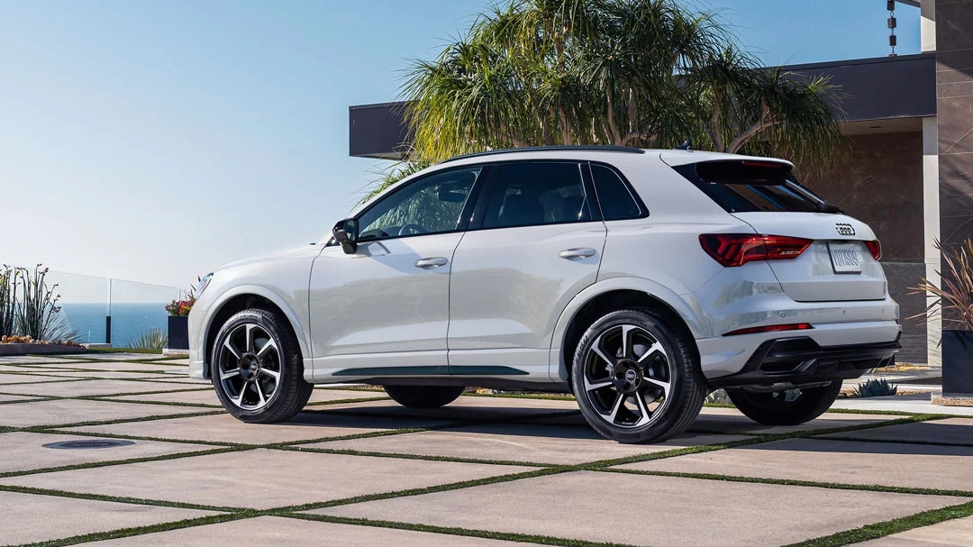 Rear view of Audi Q3 2025 parked in a paved courtyard