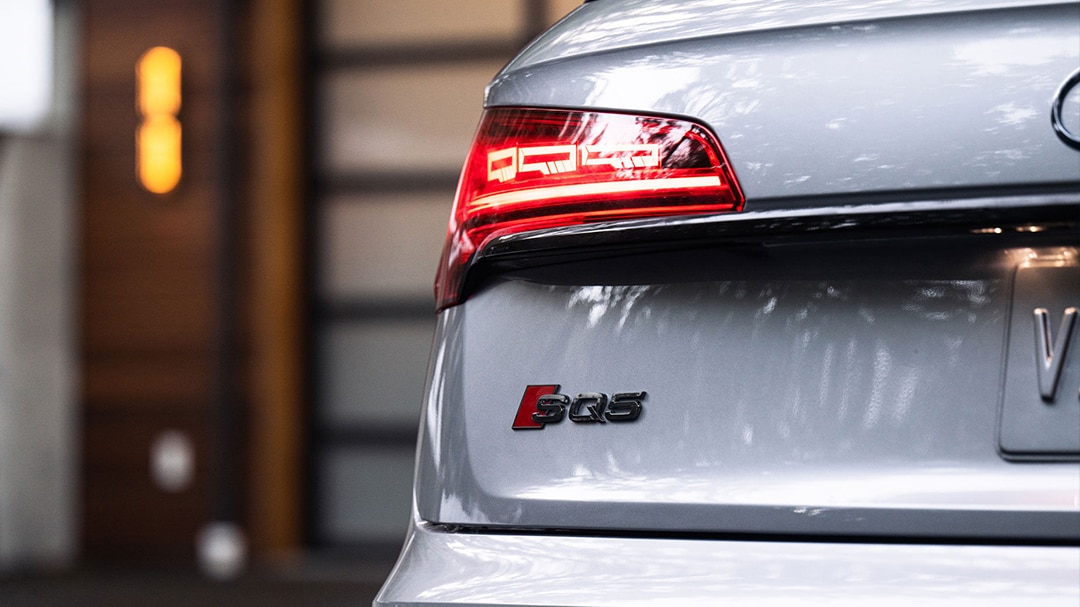 Close-up view of the Audi SQ5 rear end with headlight switched on