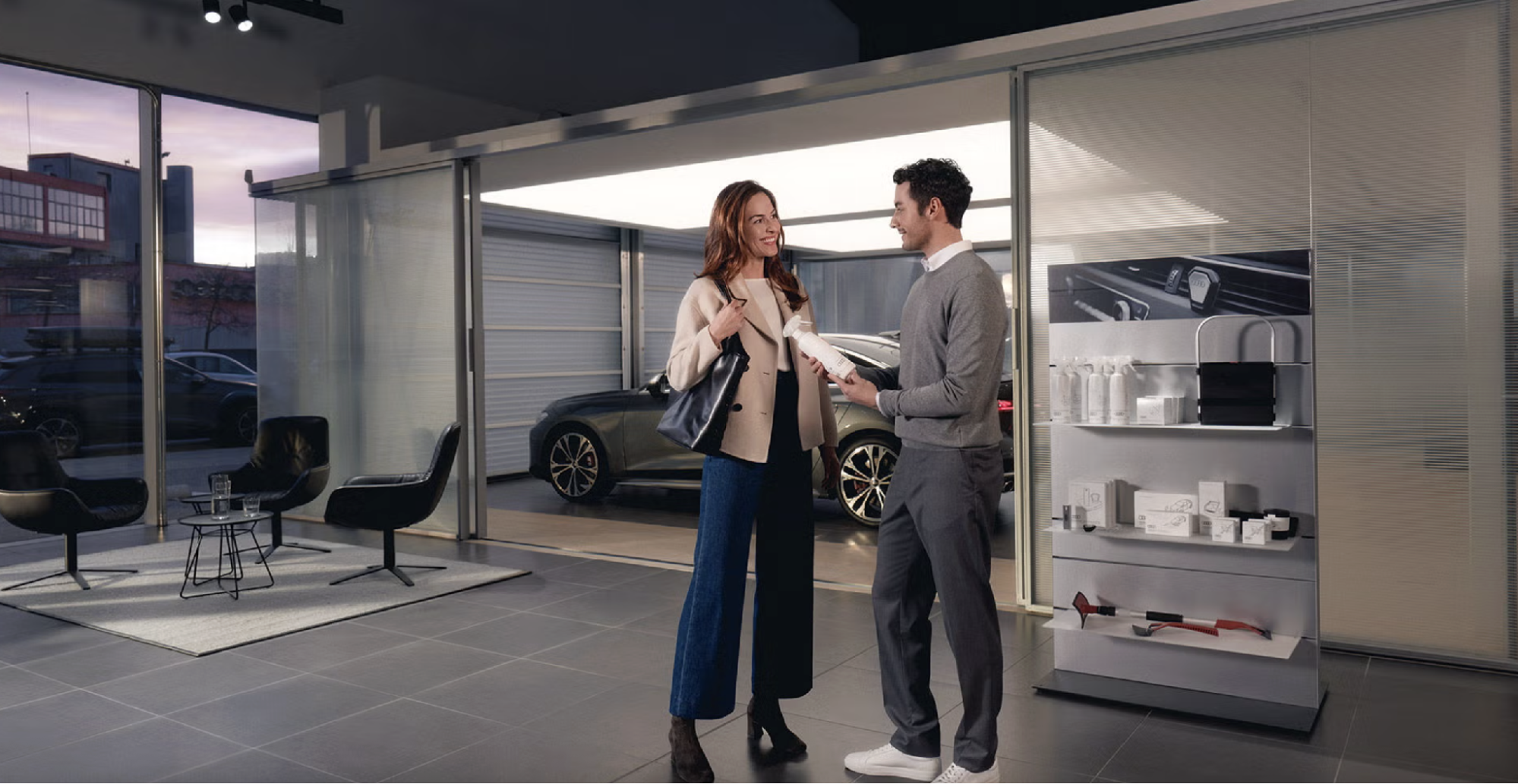 Audi service advisor showing a customer a genuine Audi care product