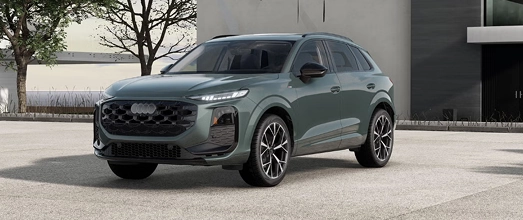 Gray Audi hybrid SUV parked beside a building, front three-quarter view