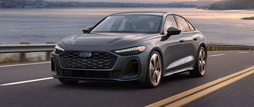 Gray Audi hatchback driving on a coastal highway