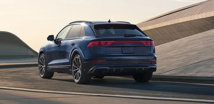 Blue Audi Q8 with Sport plus styling, rear three-quarter view