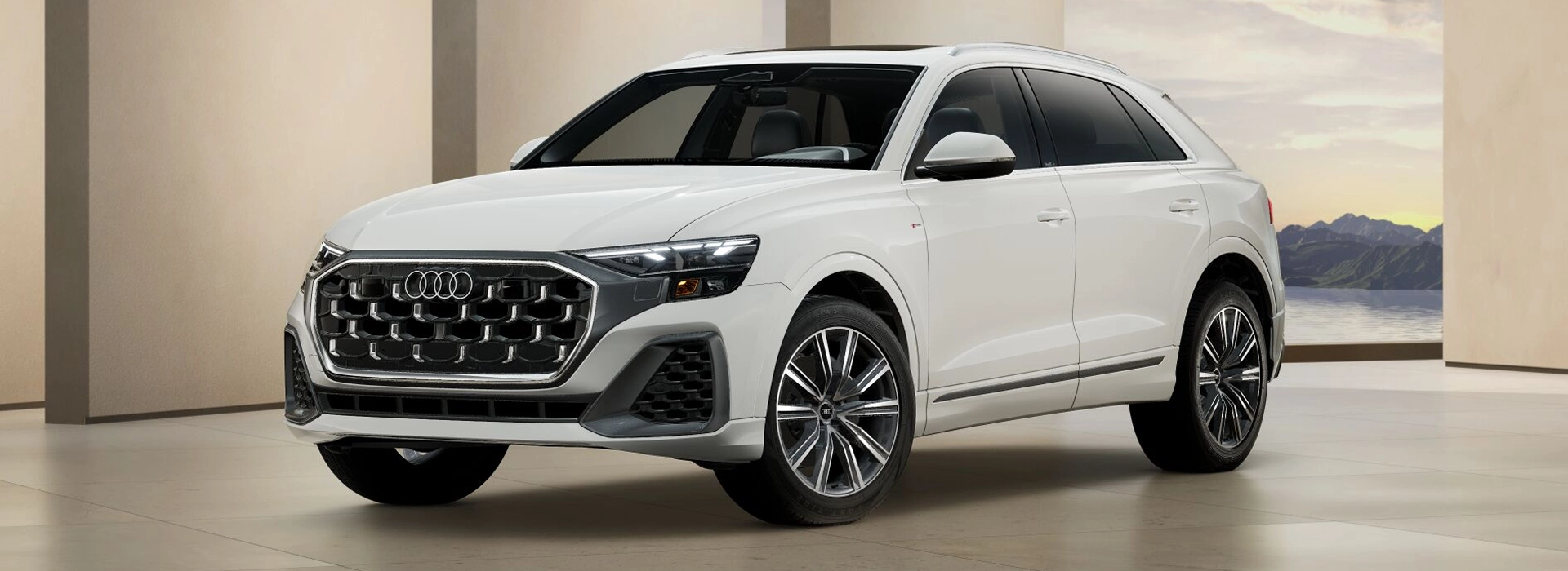 White Audi Q8 parked in a studio setting, front three-quarter view