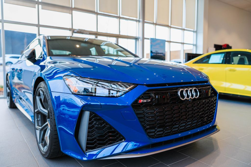 New Audi cars for sale, including blue Audi RS7, inside showroom at Audi Asheville dealership