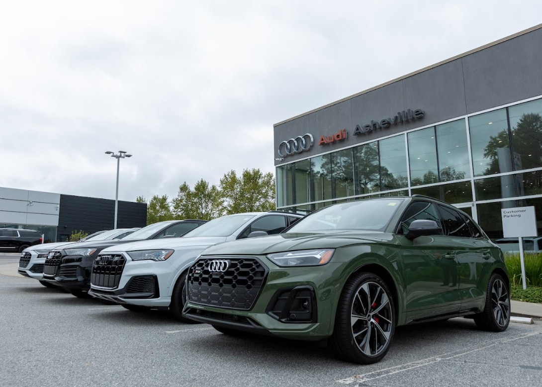 four Audi suvs lined up in front of the Audi Asheville dealership in Asheville, North Carolina