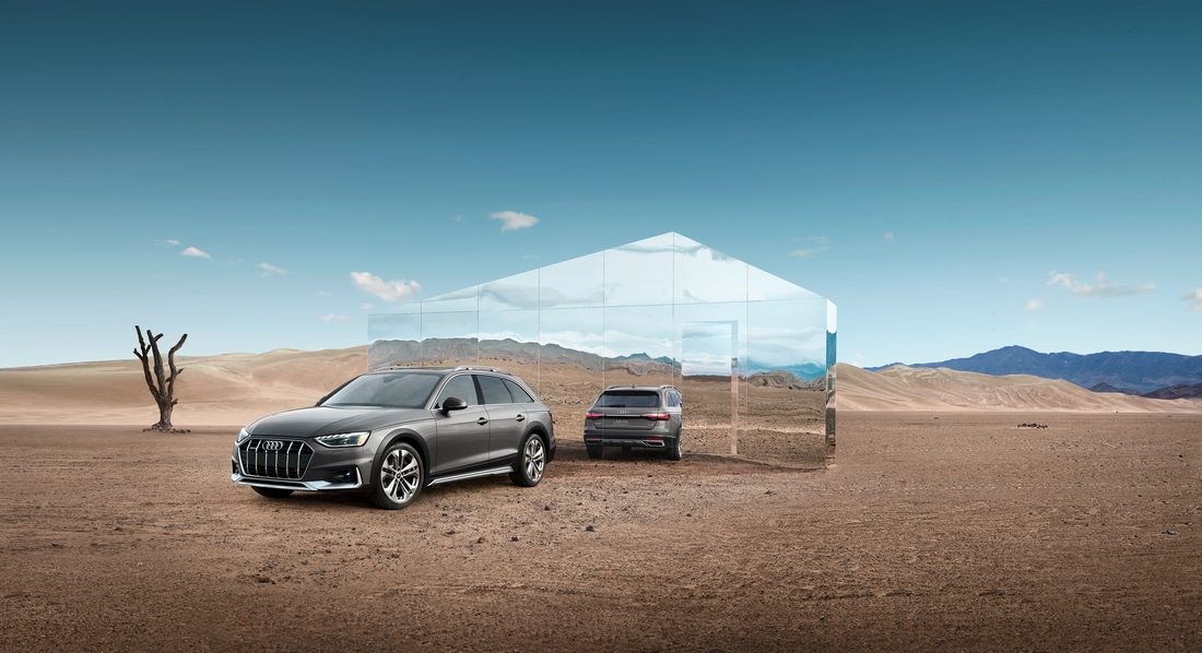 audi A4 Allroad Hatchback parked in a desert scene in font of a large mirror