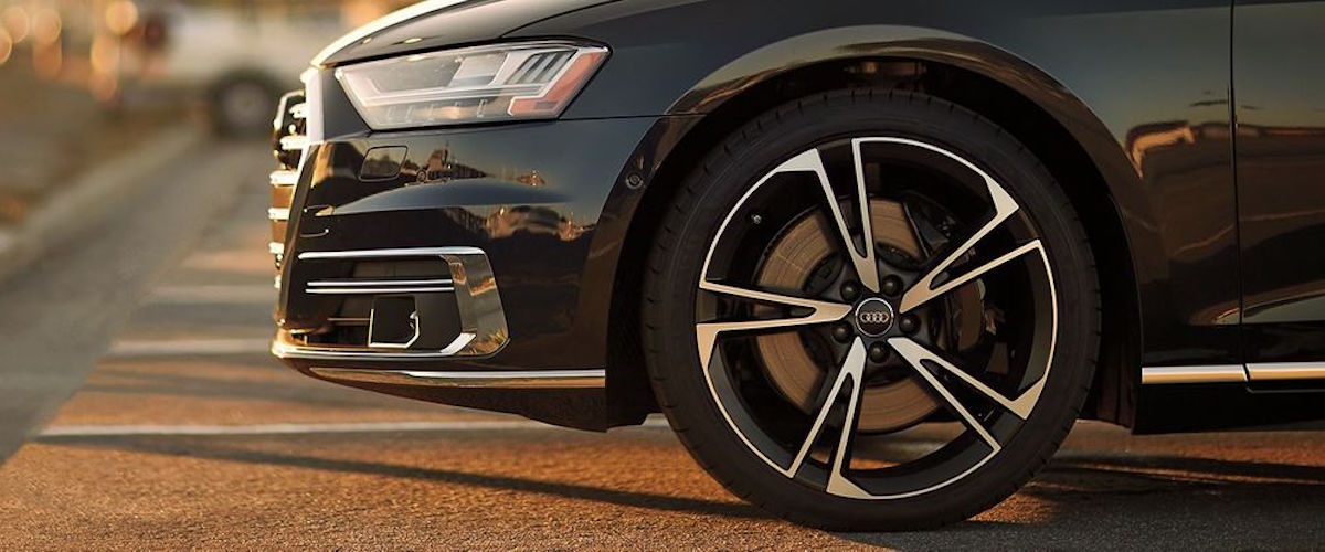 Drivers side front tire on black Audi parked in lot