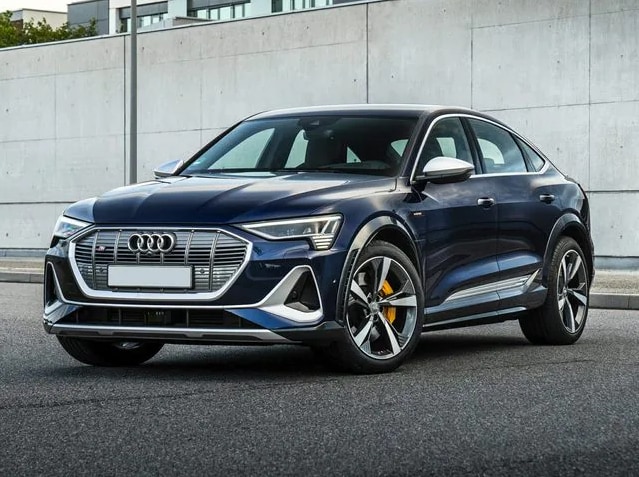 blue Audi e-tron Sportback EV parked in front of a cement wall