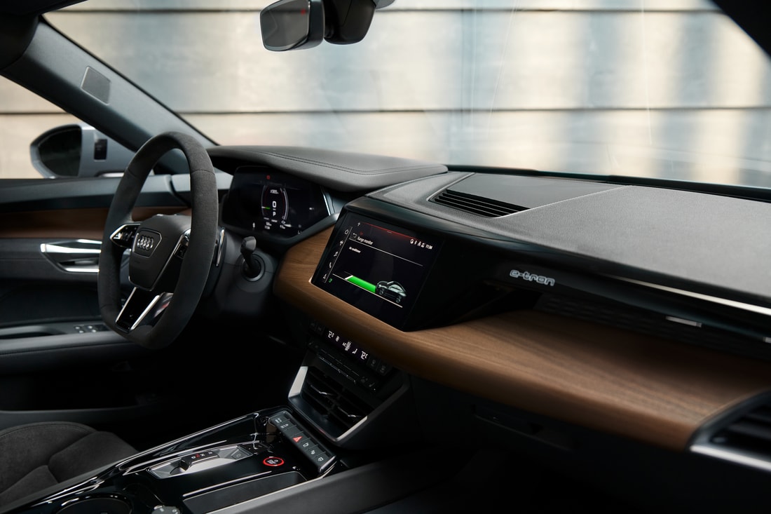 black and tan Audi e-tron GT sedan interior dash board and steering area