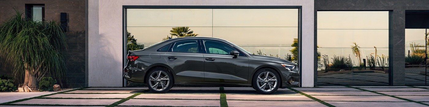 Grey A3 Premium parked near a modern home
